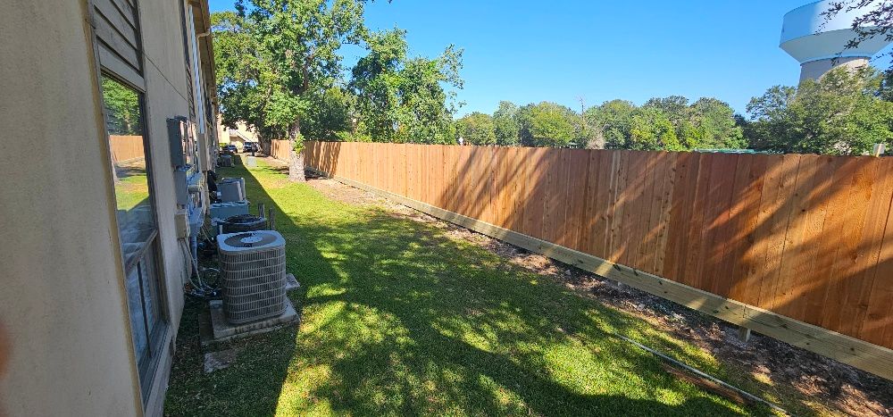 Full view of new fence installed with toe kick boards