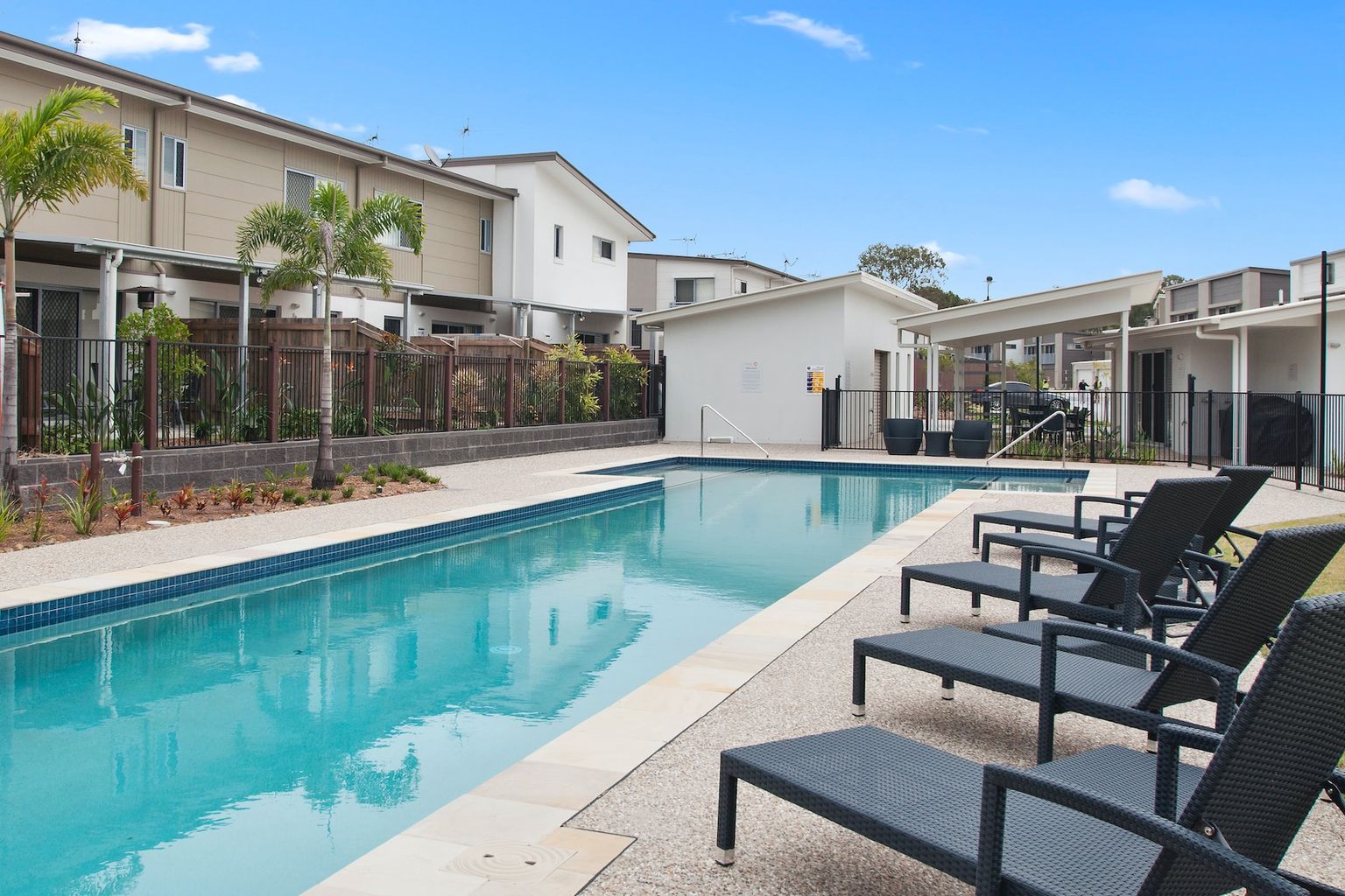 Poolside view of a scenic apartment complex pool